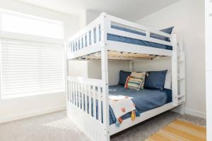 a white bunk bed in a childs bedroom at Bear Lake Beautiful Brand New End Unit in Garden City