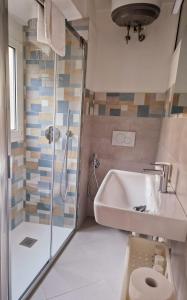 a bathroom with a shower and a sink and a toilet at Alla Mezzora - Finalborgo in Finale Ligure