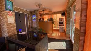 a living room with a counter and a brick wall at Casa Fanel in Buşteni