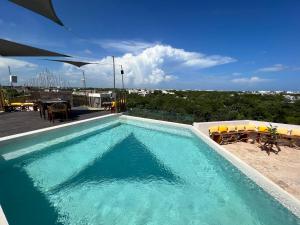 a swimming pool with a view of a city at Xkeban Tulum Adults Only in Tulum