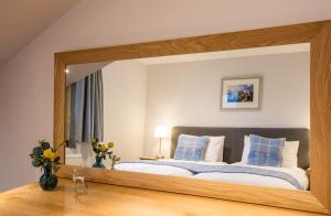 a bedroom with a large bed with a large mirror at Foinaven House in Ullapool