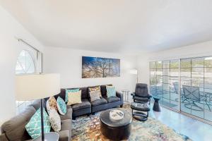 a living room with a couch and a table at Mesquite Country Club Condo D23 Permit# 1199 in Palm Springs