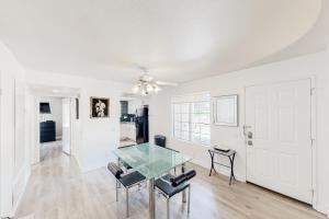 a dining room with a glass table and chairs at Mesquite Country Club Condo D23 Permit# 1199 in Palm Springs