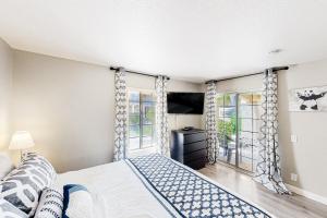 a bedroom with a bed and a window at Mesquite Country Club Condo D23 Permit# 1199 in Palm Springs