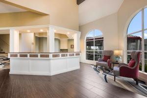 a living room filled with furniture and a large window at Best Western Harbour Pointe Lakefront in Saint Ignace
