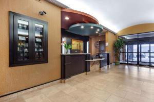 a lobby with a bar in a building at Best Western Plus The Inn at St Albert in St. Albert