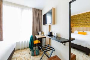 a hotel room with a bed and a desk at Best Western Mulhouse Salvator Centre in Mulhouse