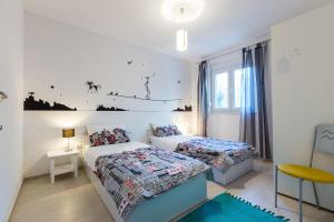 A bed or beds in a room at Apartments Bozana Bibinje