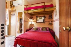 a bedroom with a bed with a red bedspread at CASA Bella in Rome
