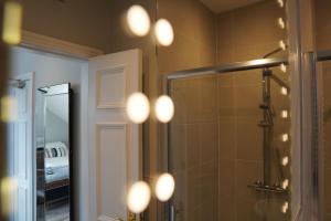 a bathroom with a shower and a mirror at St Elmos Townhouse in Derry Londonderry