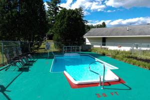a small pool with a slide in a backyard at Maple Leaf Lodge in Schroon Lake