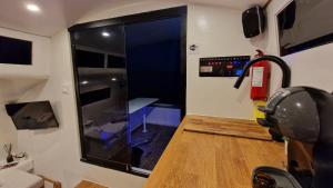 a room with a large glass door in a rv at Barco Casa Catamarã Sleepandboat in Faro
