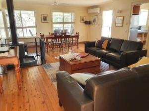 a living room with a couch and a table at Sancerre Estate in Ballandean