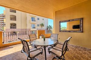 a dining room with a table and chairs on a balcony at Bella Sirena Luxury Condo 205-B in Puerto Peñasco