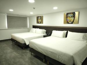 Postel nebo postele na pokoji v ubytování Hotel Qatar Cali