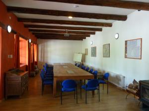 a dining room with a long table and blue chairs at Casa Chueca - DiVino in Talca +18 photos