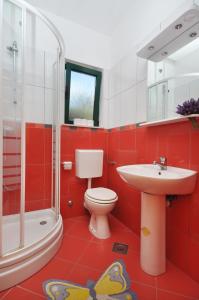 a bathroom with a toilet and a sink and a shower at Apartments by the sea Vela Luka, Korcula - 9244 in Vela Luka +14 photos