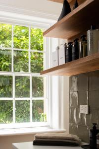 a kitchen with a large window and a counter top at Henry’s on Balfour - Historic understated luxury in Launceston