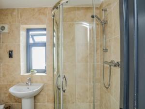 a bathroom with a sink and a shower at Trem Y Borth Apartment in Abersoch