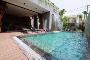 a swimming pool in the middle of a house at Vyanh villa in Dong Hoi