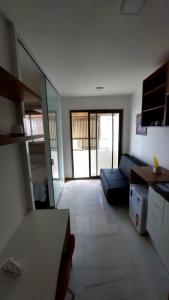 a living room with a couch and a large mirror at Apartamento Smart Costa Azul in Salvador