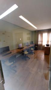an office with two desks and chairs with laptops on them at Apartamento Smart Costa Azul in Salvador
