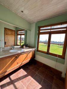 a bathroom with a sink and a large window at Casa Mario Boutique Hotel 