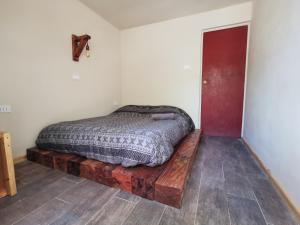 a bed sitting on a wooden platform in a room at Vientos - La Yareta in San Pedro de Atacama