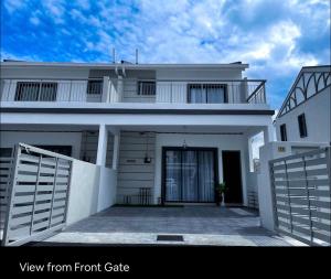 a view from front gate of a white house at New 2 storey-Majestic Homestay 3 min to Night Market in Brinchang