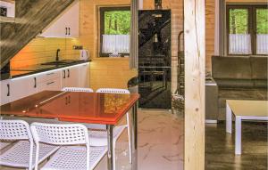 a kitchen with a table and chairs in a room at 2 Bedroom Pet Friendly Home In Ostroda in Ostróda +7 photos