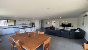 a kitchen and living room with a table and a couch at Adriana Retreat, 20 Adriana Retreat in Jurien Bay