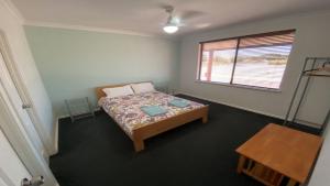 a small bedroom with a bed and a window at Adriana Retreat, 20 Adriana Retreat in Jurien Bay