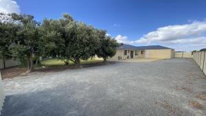 a driveway in front of a house with trees at Adriana Retreat, 20 Adriana Retreat in Jurien Bay
