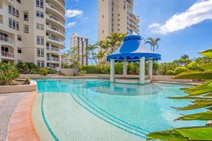a swimming pool with a gazebo in the middle at Stunning 2 bedroom Ocean View Apartment in Gold Coast
