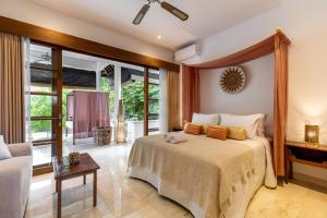 a bedroom with a bed and a living room at Luxury Villa in City Center w/ Natural Pool La Bohemia Residence Villas in Ubud +97 photos