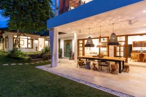 a dining area of a house with a table and chairs at Luxury Villa in City Center w/ Natural Pool La Bohemia Residence Villas in Ubud