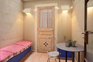 a small room with a bed and a table and a door at Romantic In Trendy Gracia in Barcelona