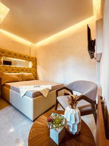 a small room with a bed and a table at GTC Pension House in Santa Rita