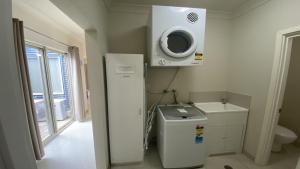 a bathroom with a refrigerator and a microwave at Unit 63 Seafront Estate in Jurien Bay