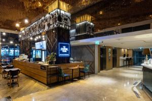 a restaurant with a bar and tables and chairs at Holiday Inn Express Bangkok Sukhumvit 11 by IHG in Bangkok