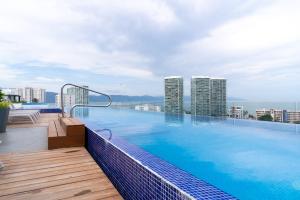 a swimming pool on top of a building with tall buildings at ¡Hermoso Condo con espectacular vista a la bahia!! in Puerto Vallarta