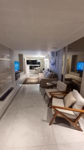 a large living room with couches and a couch at Apartamento completo na praia brava in Itajaí