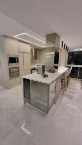 a large kitchen with a large island in a room at Apartamento completo na praia brava in Itajaí