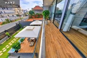two tables on a balcony of a building at HANZ Premium Villa Pandora Dalat in Da Thien