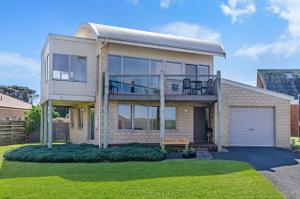 a house with a balcony and a garage at Southern Waves in Port Fairy