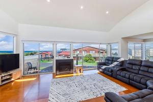 a large living room with a couch and a television at Southern Waves in Port Fairy