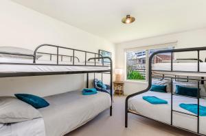 two bunk beds in a room with a window at Southern Waves in Port Fairy
