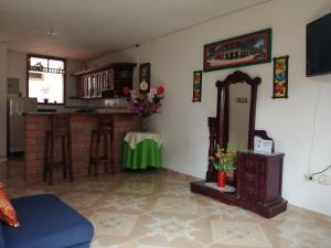a living room with a mirror and a counter at Las Orquídeas Jardín Casa Hotel in Jardin