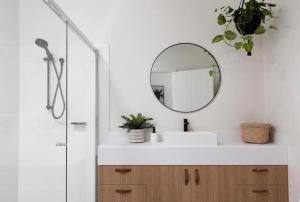 a bathroom with a sink and a mirror at Currumbin Sanctuary Beach Abode in Gold Coast