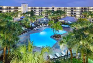 an aerial view of a resort pool with palm trees at Staybridge Suites Orlando Royale Parc Suites, an IHG Hotel in Orlando